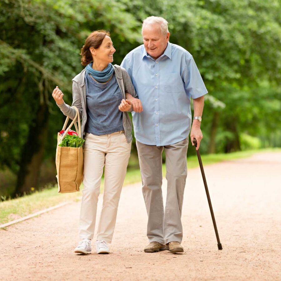A Serenity Care carer walking outdoors with a client in Gosport