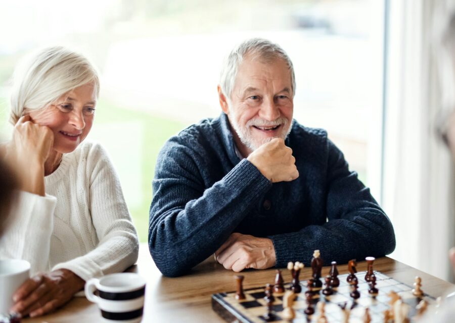 Older people enjoying a game and conversation together